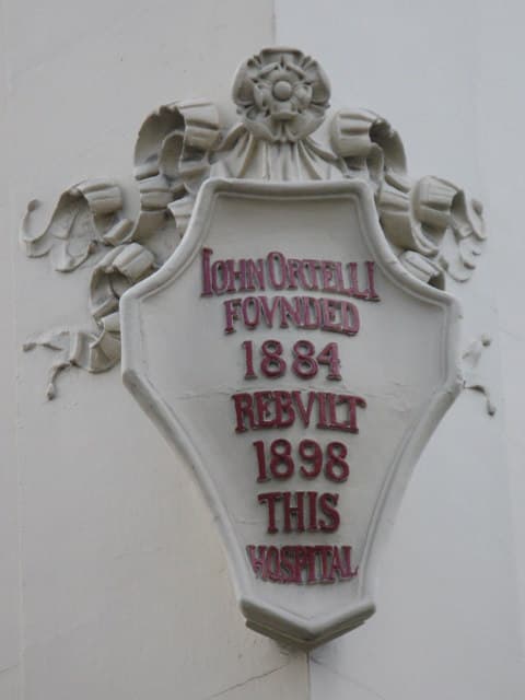 John Ortelli white plaque